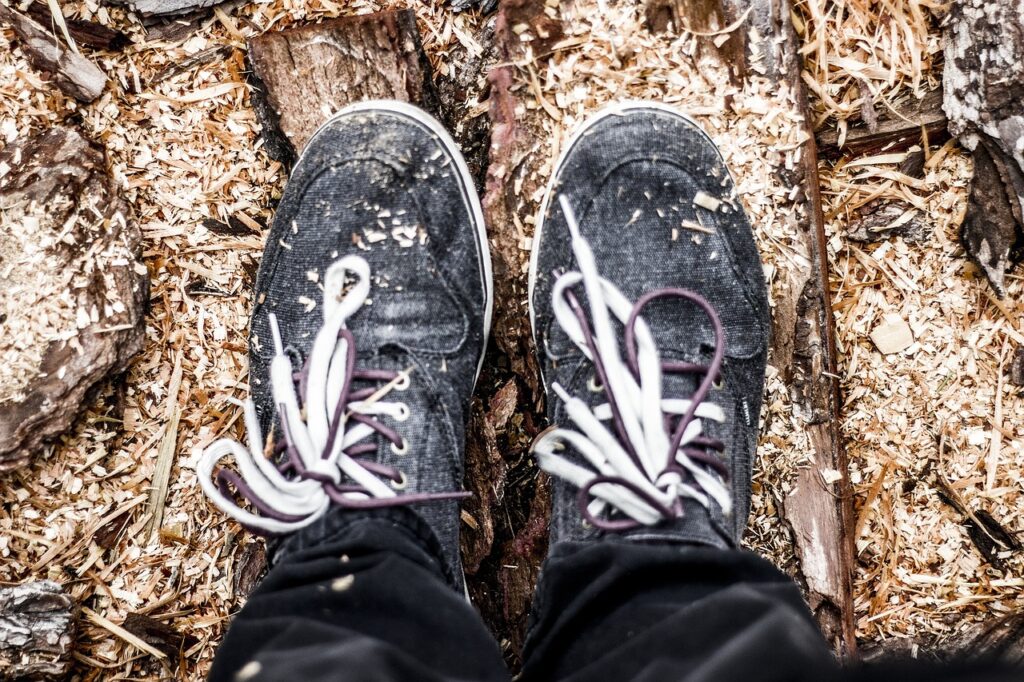 木くずの上に立つスニーカーと足元のアップ写真