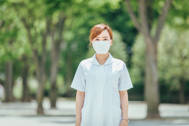 マスクを着用した看護師が屋外で立っている姿